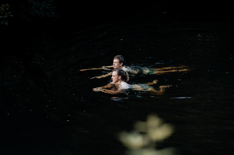 couple swimming in river